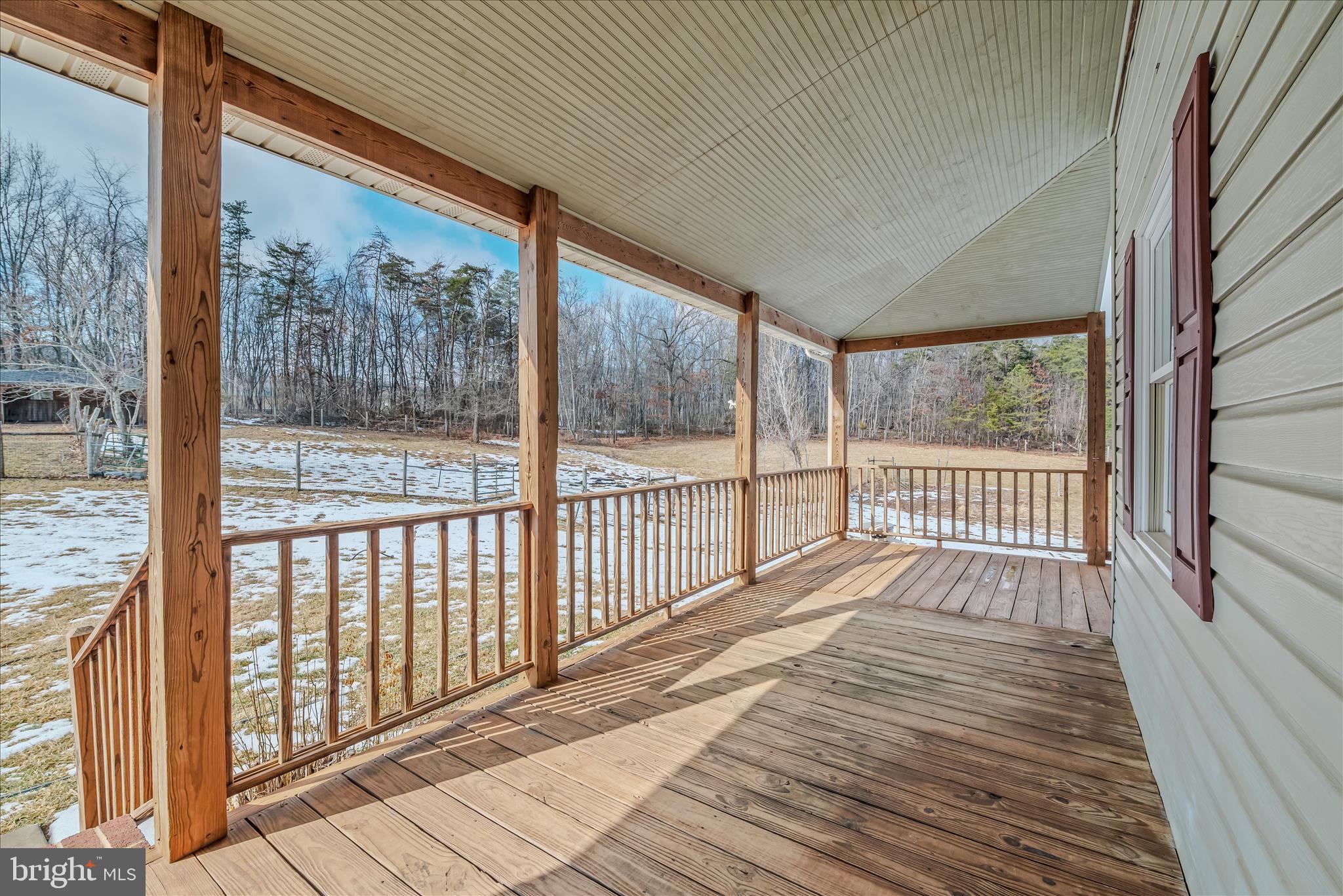 344 Tub Run Hollow Road Hedgesville, WV 25427 - Photo 28 of 85 a view of a wooden balcony with a floor to ceiling window