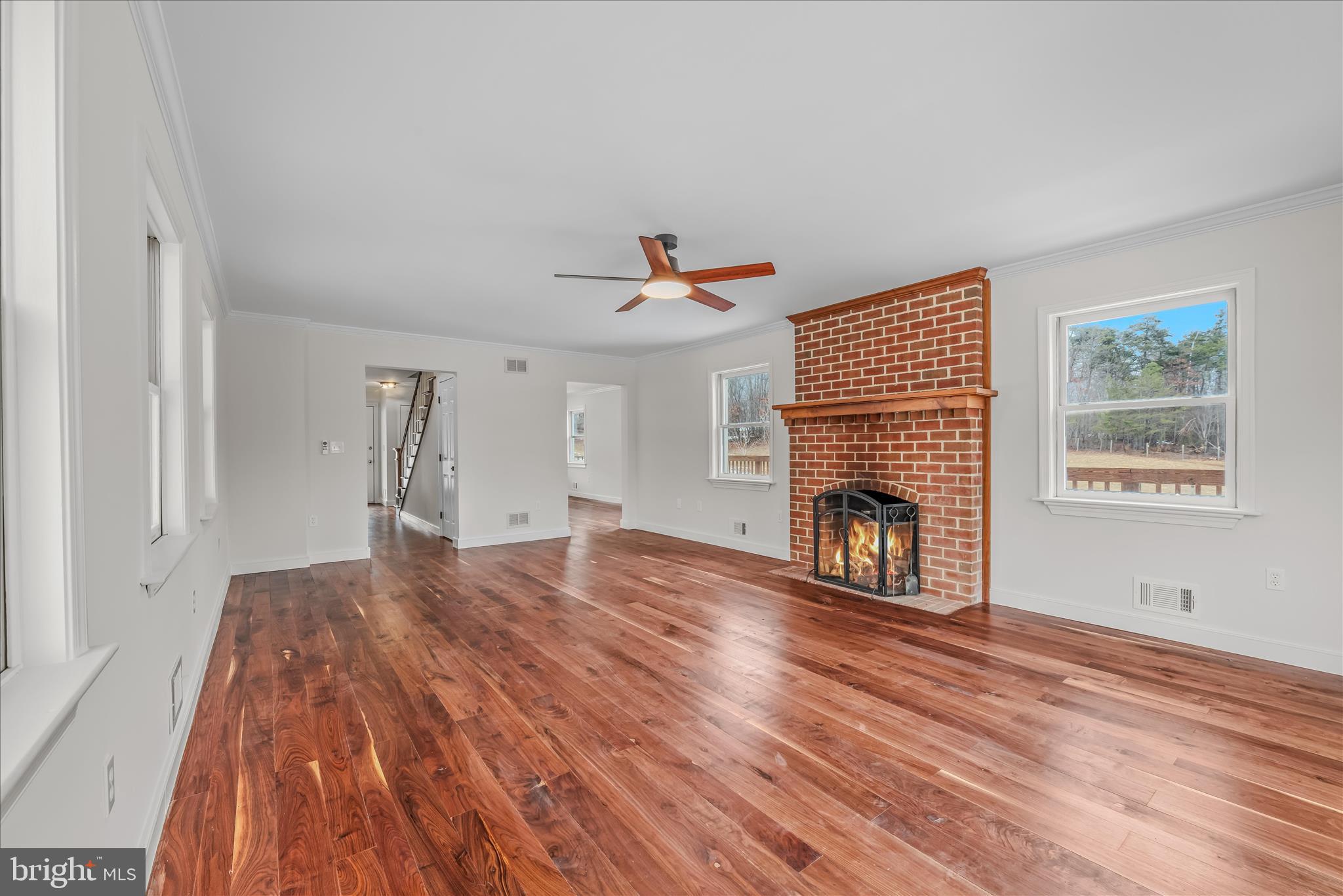 344 Tub Run Hollow Road Hedgesville, WV 25427 - Photo 43 of 85 a view of empty room with fireplace and wooden floor
