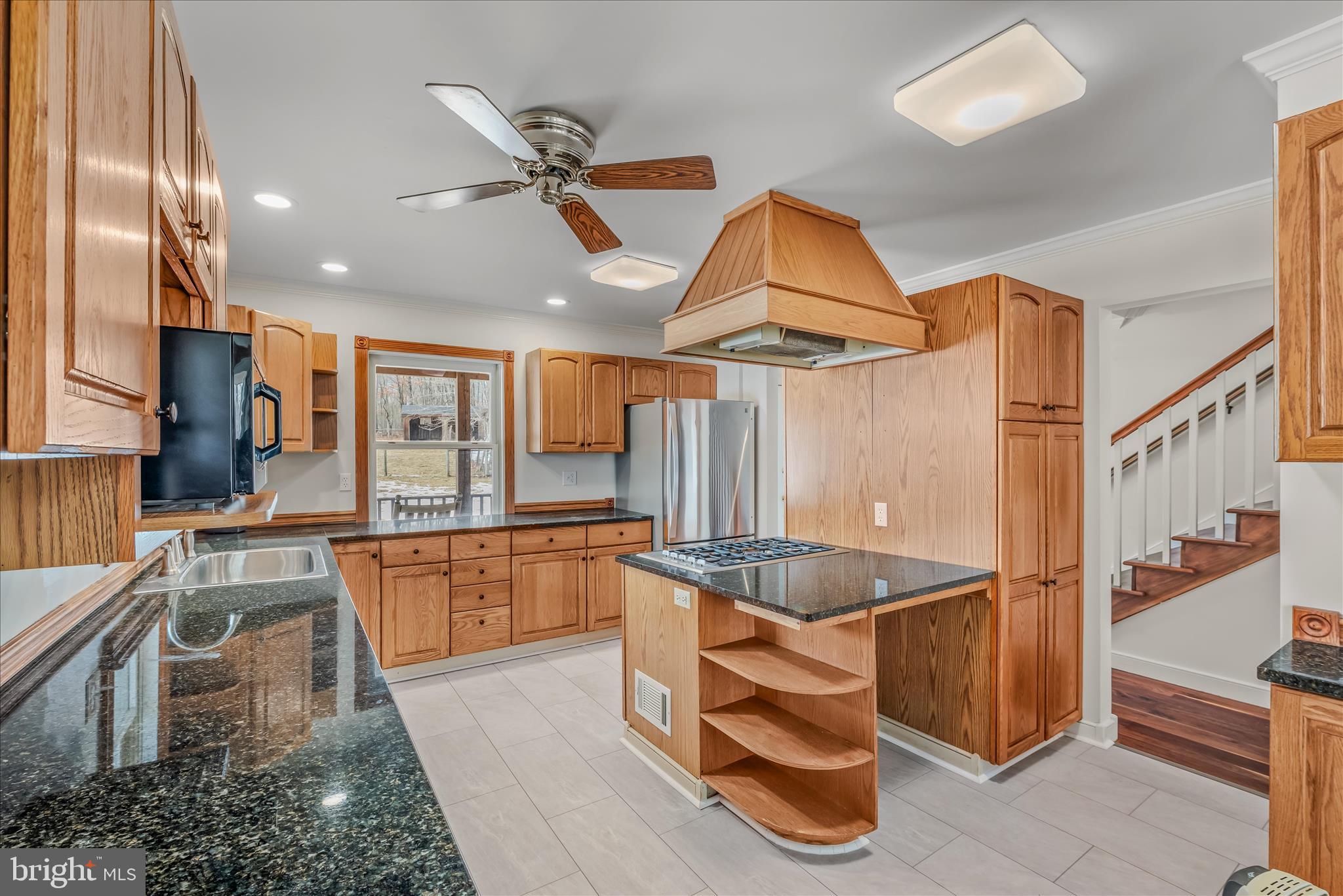 344 Tub Run Hollow Road Hedgesville, WV 25427 - Photo 44 of 85 a kitchen with stainless steel appliances granite countertop a sink and a refrigerator