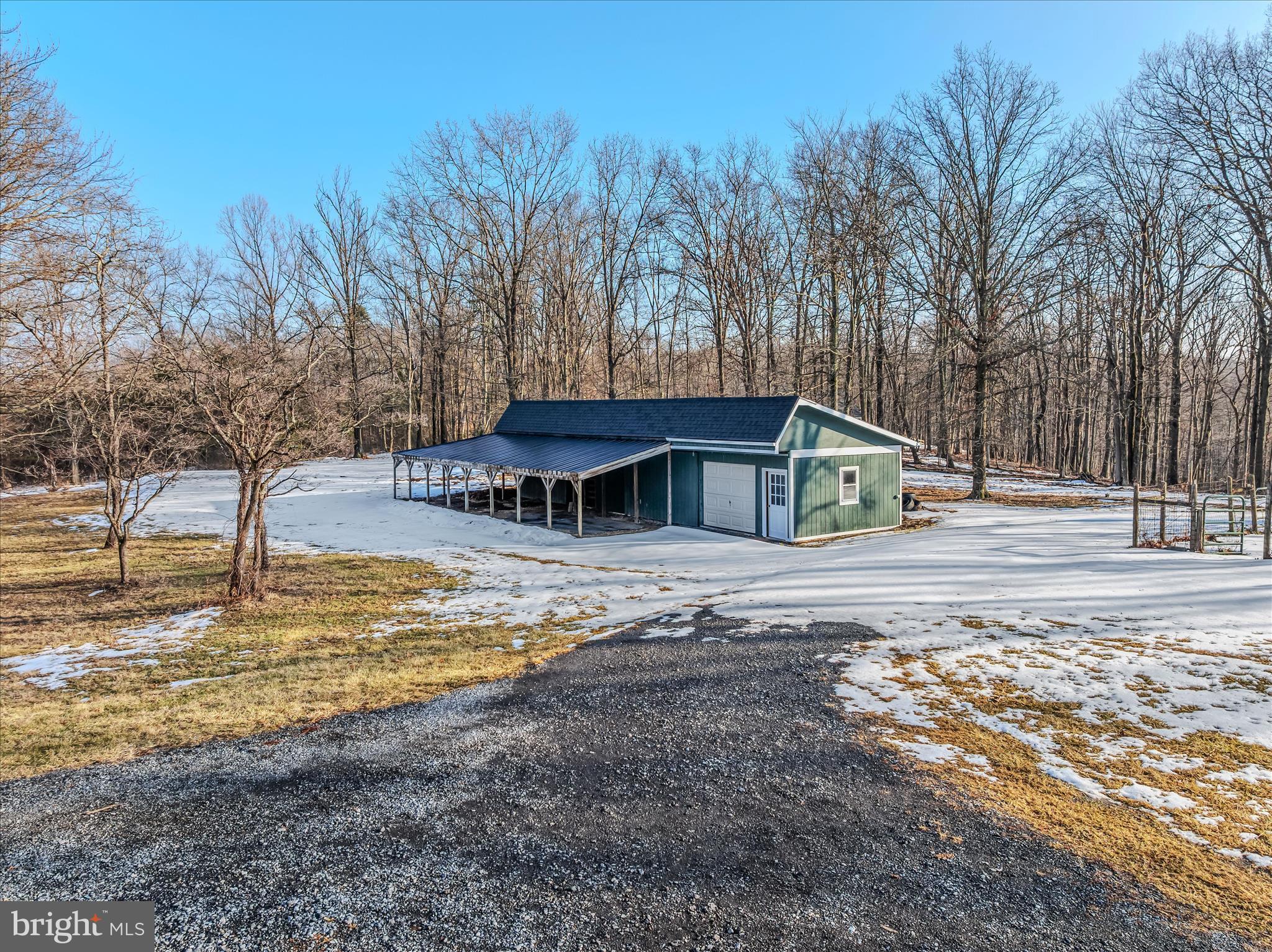 344 Tub Run Hollow Road Hedgesville, WV 25427 - Photo 71 of 85 a view of a house with pool and trees in the background