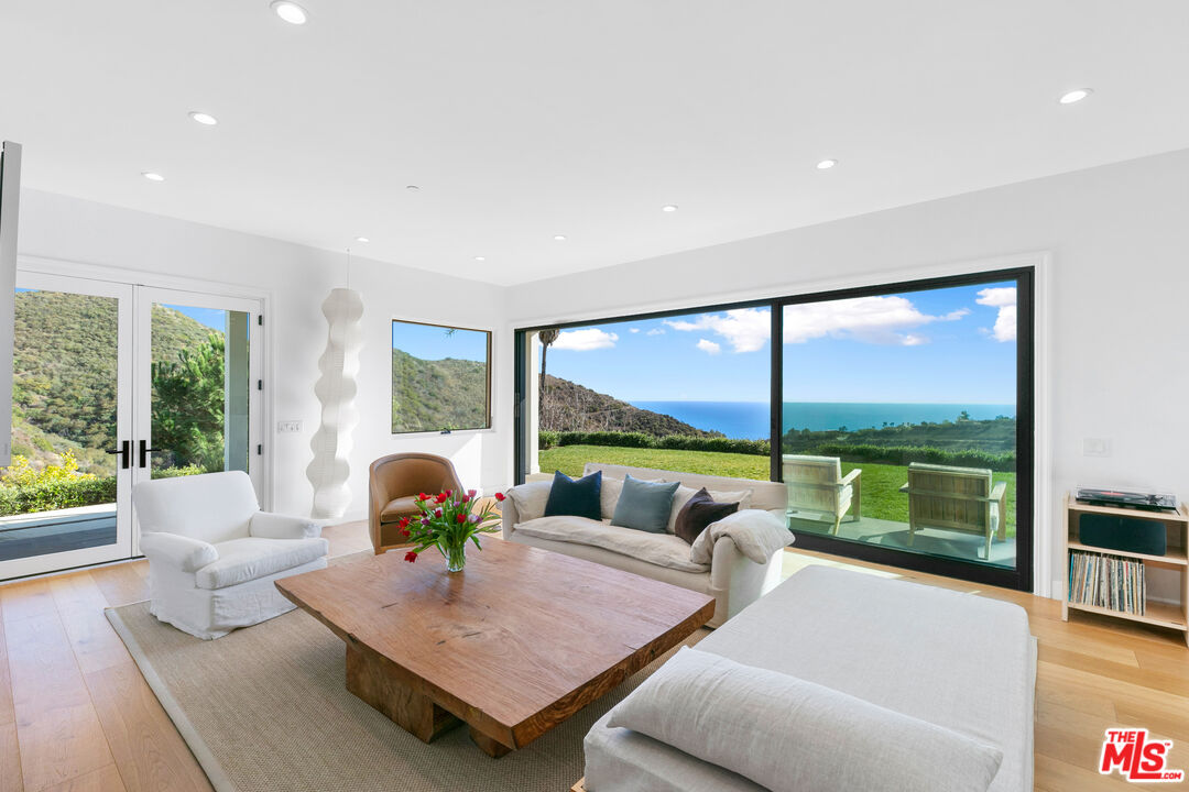 26575 Ocean View Drive Malibu, CA 90265 - Photo 1 of 40 a living room with furniture and a large window