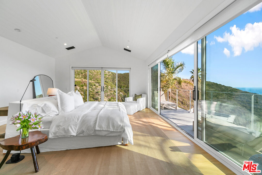 26575 Ocean View Drive Malibu, CA 90265 - Photo 13 of 40 a bedroom with a bed and a large window