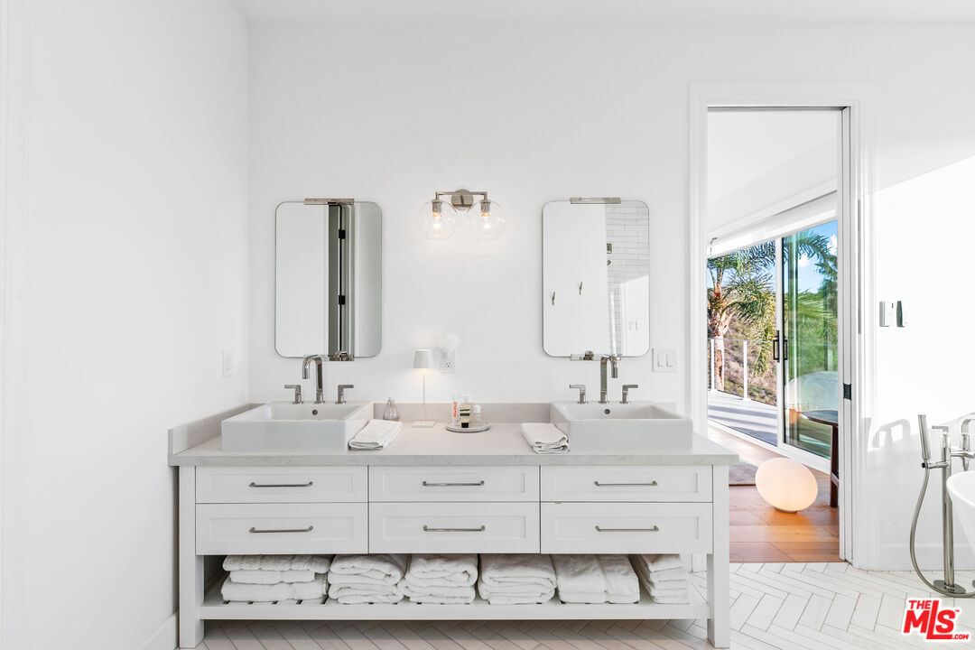26575 Ocean View Drive Malibu, CA 90265 - Photo 20 of 40 a bathroom with a sink double vanity and a mirror