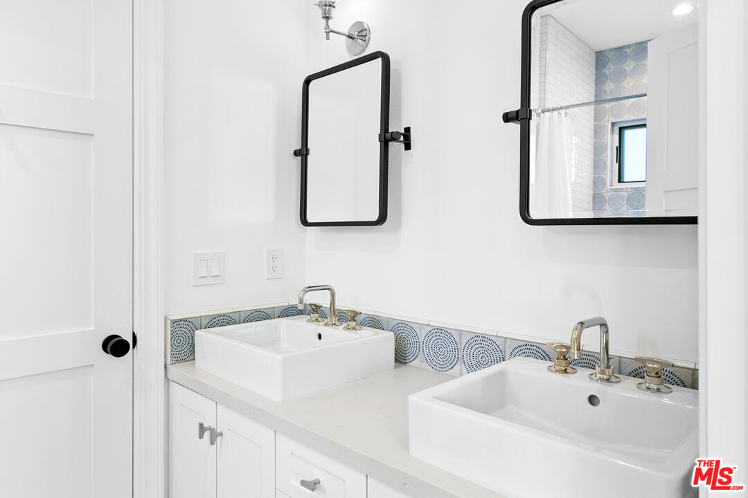 26575 Ocean View Drive Malibu, CA 90265 - Photo 27 of 40 a bathroom with a sink and mirror