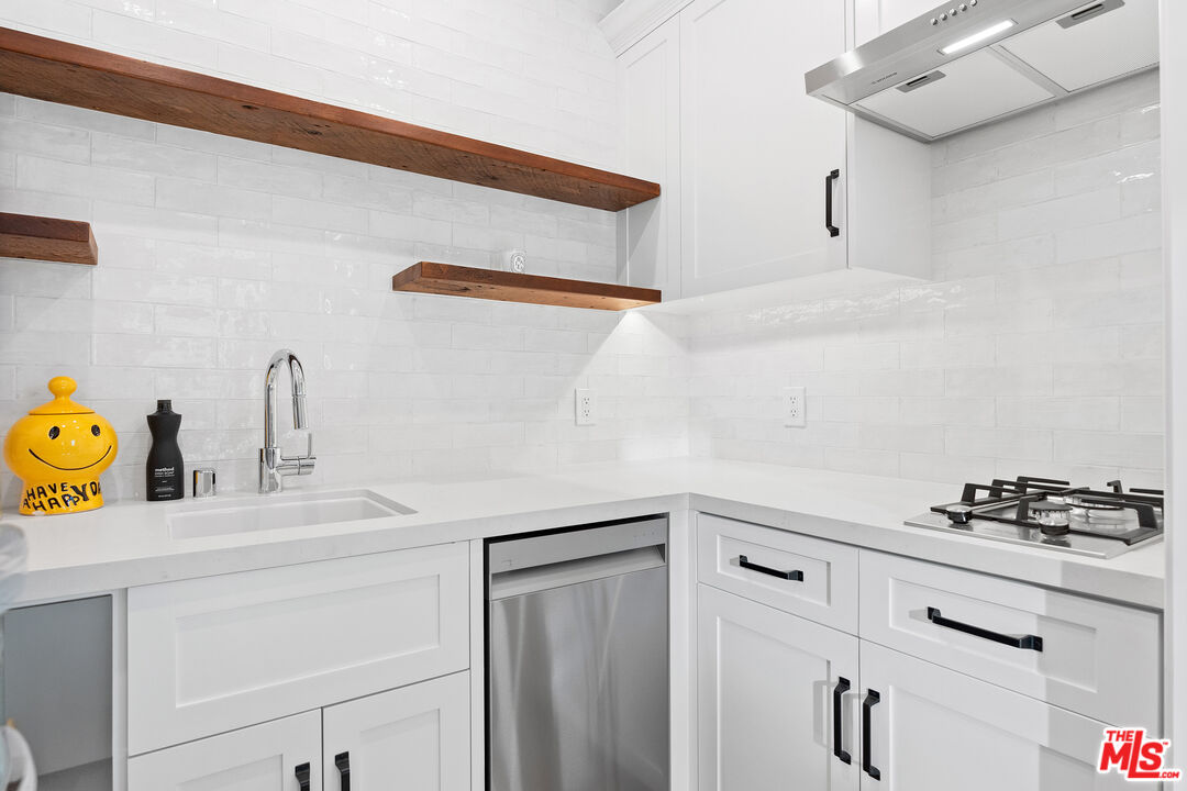26575 Ocean View Drive Malibu, CA 90265 - Photo 34 of 40 a kitchen with a sink and a stove