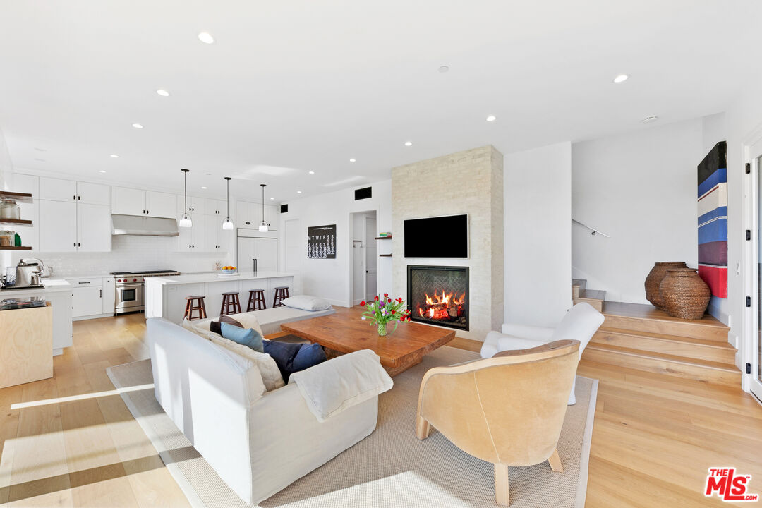 26575 Ocean View Drive Malibu, CA 90265 - Photo 5 of 40 a living room with furniture a flat screen tv and kitchen view