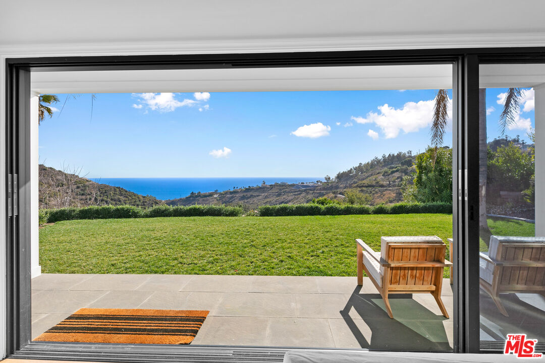 26575 Ocean View Drive Malibu, CA 90265 - Photo 6 of 40 a view of a patio with a table chairs and a table