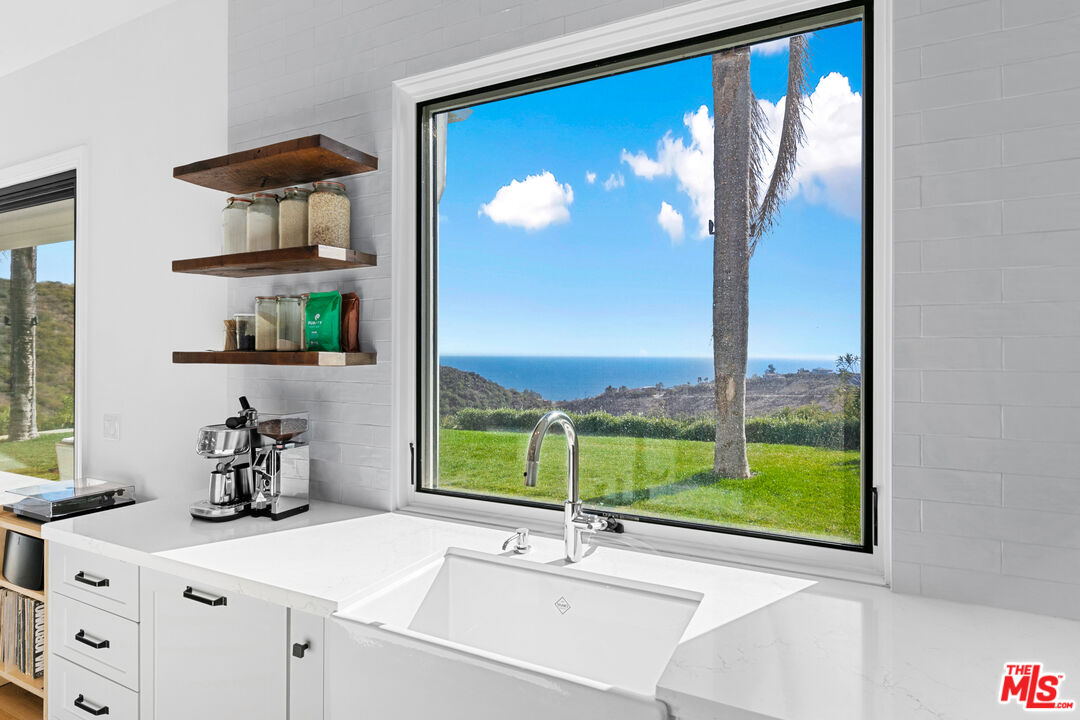 26575 Ocean View Drive Malibu, CA 90265 - Photo 9 of 40 a bathroom with a sink and a mirror