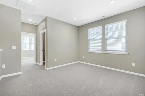an empty room with windows and closet