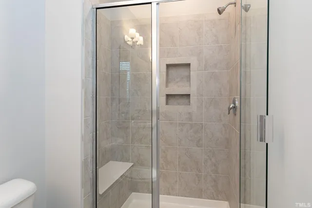 a bathroom with a shower and toilet