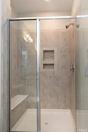 a bathroom with a glass shower door