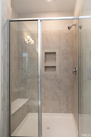 a bathroom with a glass shower door
