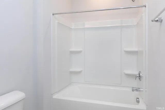 a bathroom with a shower and a bath tub