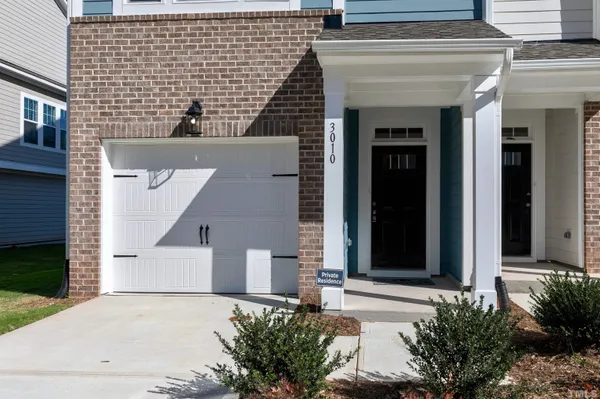 an front view of a house with a yard