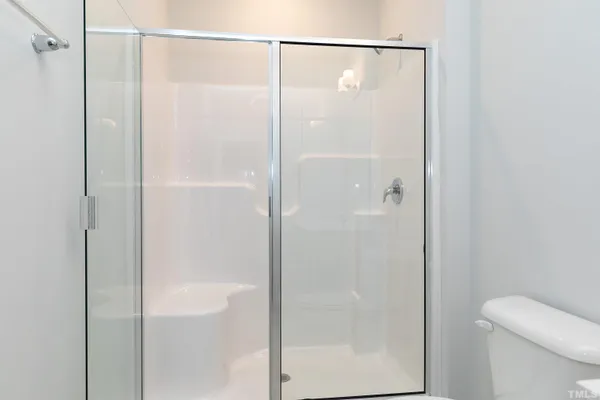 a bathroom with a glass shower door