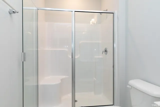 a bathroom with a glass shower door