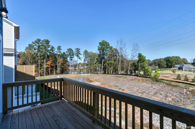 a view of a balcony with wooden fence