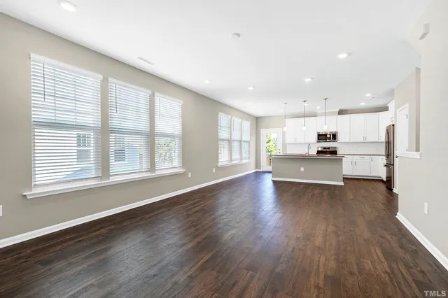 a view of kitchen with wooden floor and electronic appliances