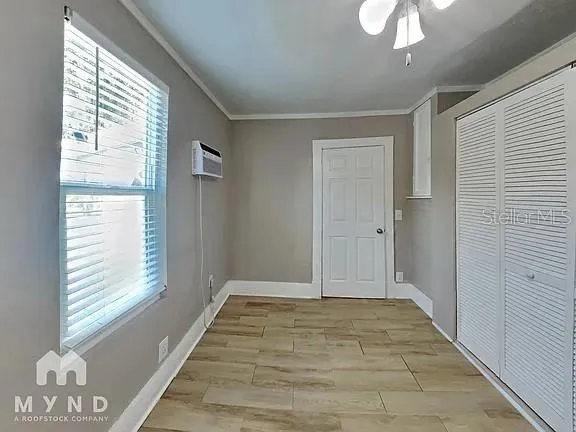 a picture of a room with a white wall and a painting