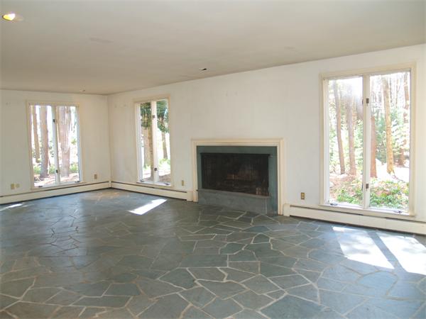24 Conant Road Lincoln, MA 01773 - Photo 2 of 10 an empty room with windows and fireplace