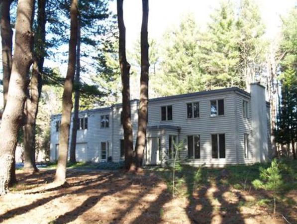 24 Conant Road Lincoln, MA 01773 - Photo 9 of 10 a view of a brick house next to a yard with large tree