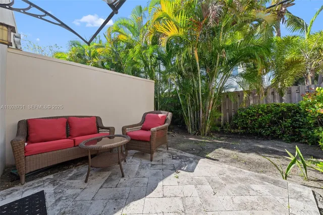 a backyard of a house with outdoor seating