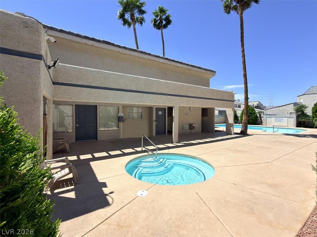 6250 West Flamingo Road, Unit 93 Las Vegas, NV 89103 - Photo 37 of 38 This inviting outdoor space features a sparkling pool and spa, perfect for relaxation under the sun.