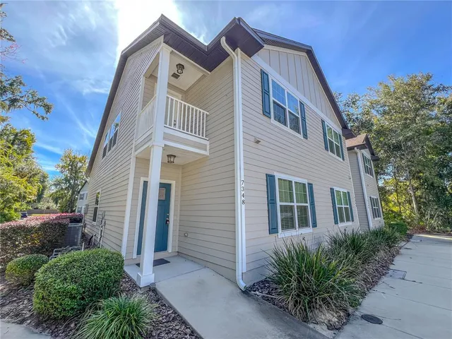 a front view of a house with plants
