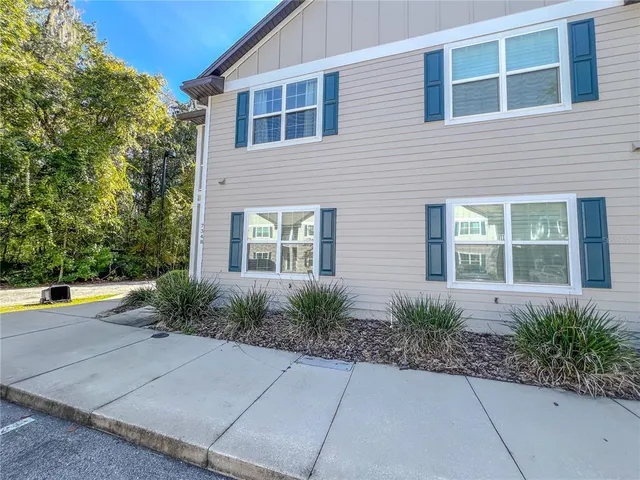 a view of a house with potted plants