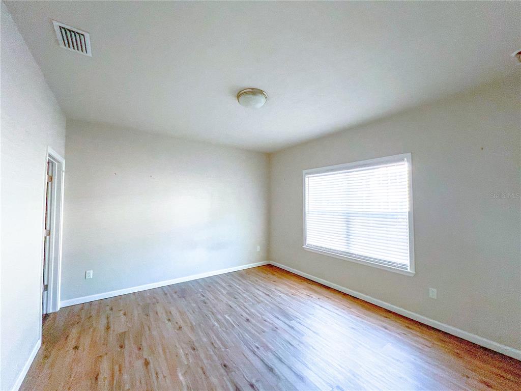 7348 Northwest 47th Way Gainesville, FL 32653 - Photo 3 of 13 an empty room with wooden floor and windows
