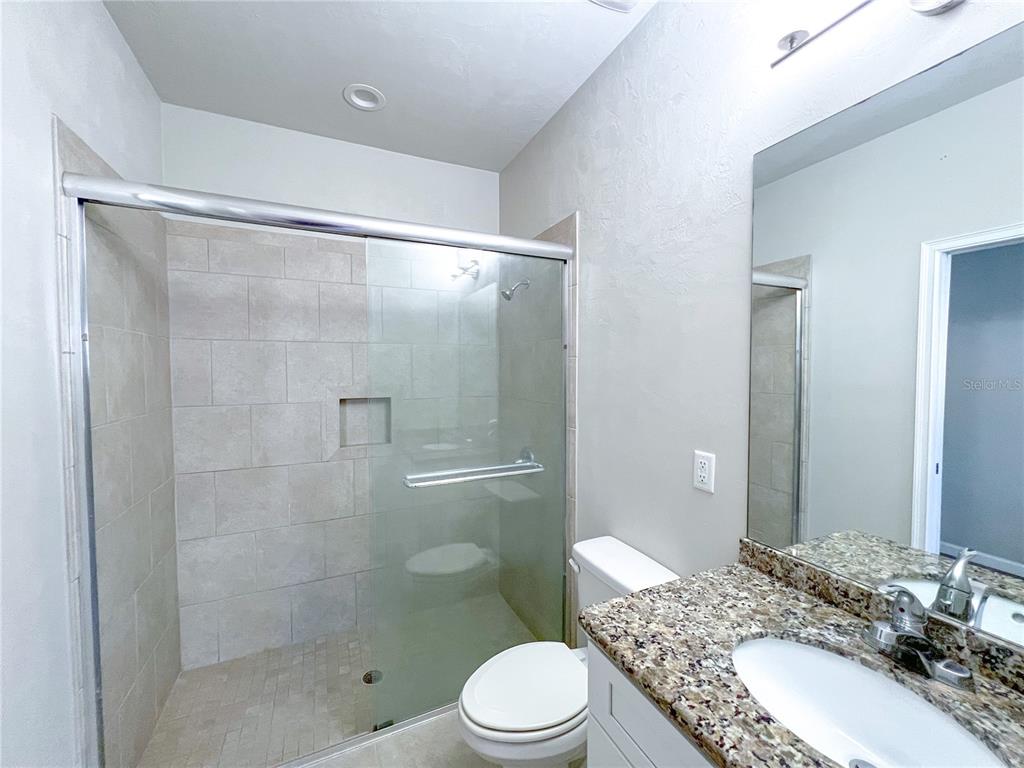 7348 Northwest 47th Way Gainesville, FL 32653 - Photo 5 of 13 a bathroom with a sink toilet and shower