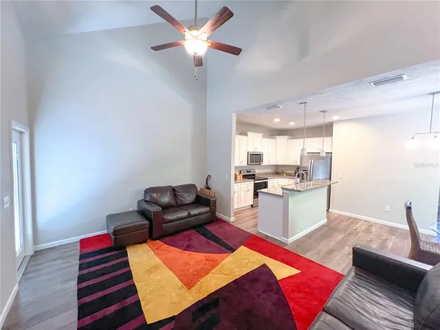 a living room with furniture and kitchen view