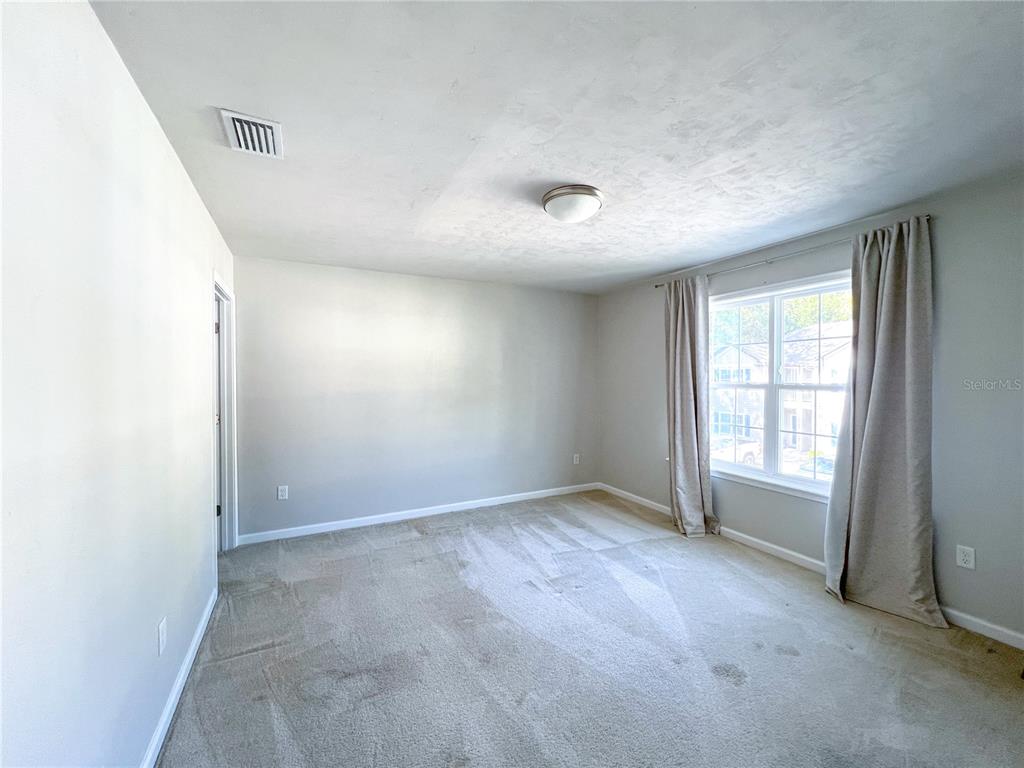 7348 Northwest 47th Way Gainesville, FL 32653 - Photo 10 of 13 an empty room with windows and closet
