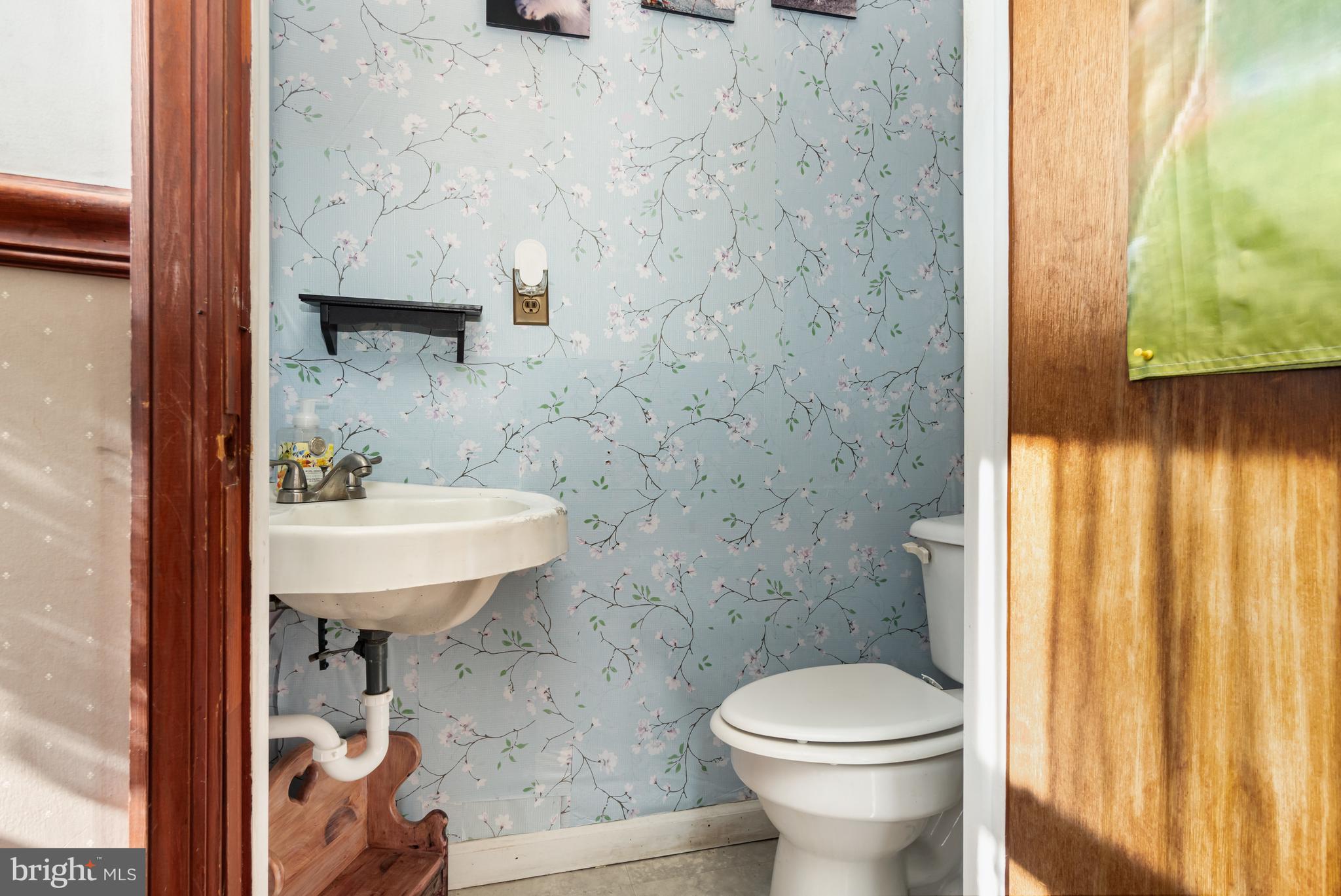 162 Swatara Road Shenandoah, PA 17976 - Photo 14 of 37 a bathroom with a sink a toilet and shower curtain