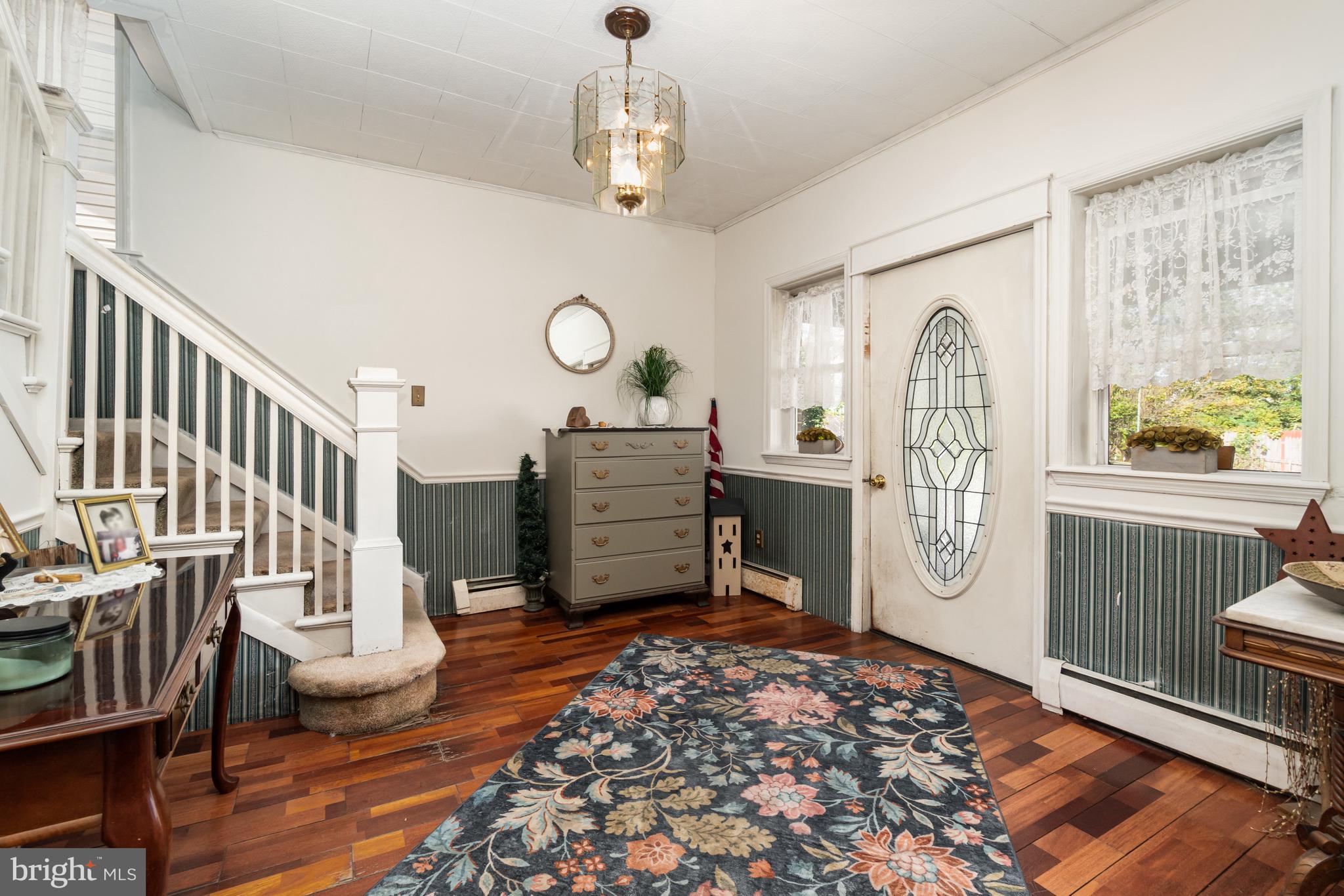 162 Swatara Road Shenandoah, PA 17976 - Photo 5 of 37 a view of a hallway with wooden floor windows and a chandelier