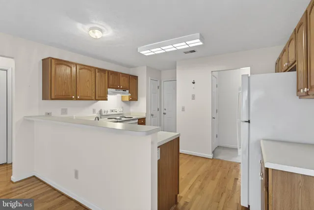 a kitchen with stainless steel appliances granite countertop a refrigerator sink and cabinets