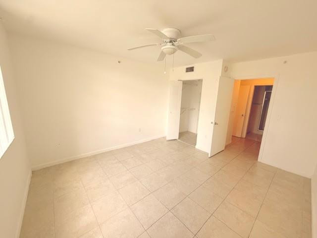 2011 Renaissance Boulevard, Unit 103 Miramar, FL 33025 - Photo 17 of 25 an empty room with fan and entrance