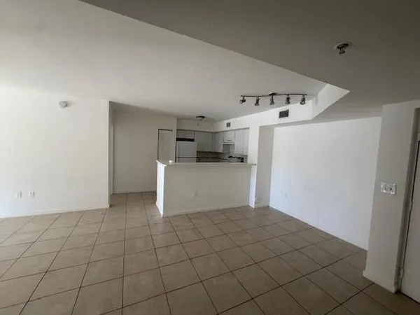 a view of an empty room and a window