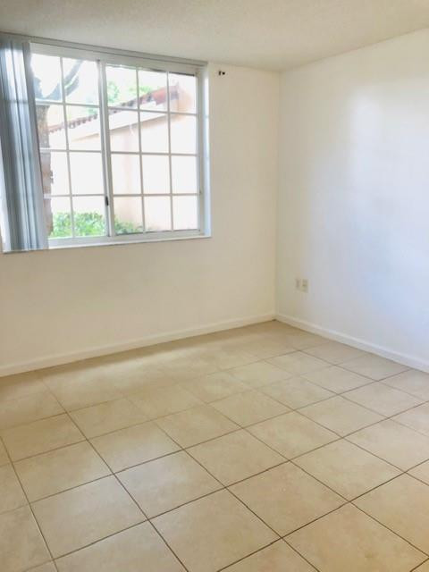 2011 Renaissance Boulevard, Unit 103 Miramar, FL 33025 - Photo 10 of 25 an empty room with a window