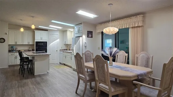 a dining room with furniture and wooden floor