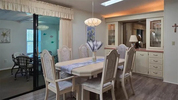a view of a dining room with furniture and wooden floor