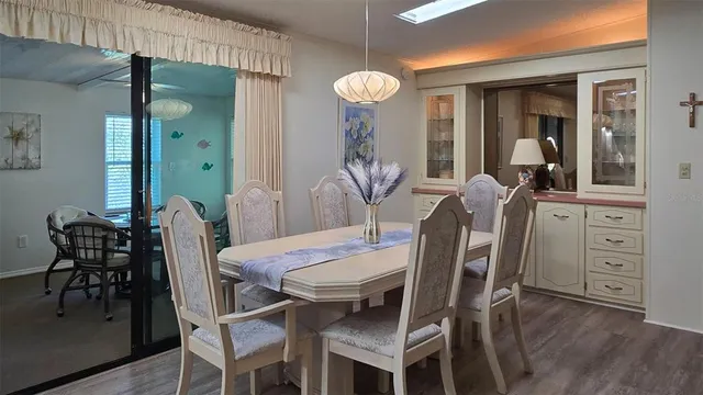 a view of a dining room with furniture and wooden floor