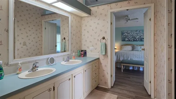 a en suite bathroom with double vanity sinks and a mirror