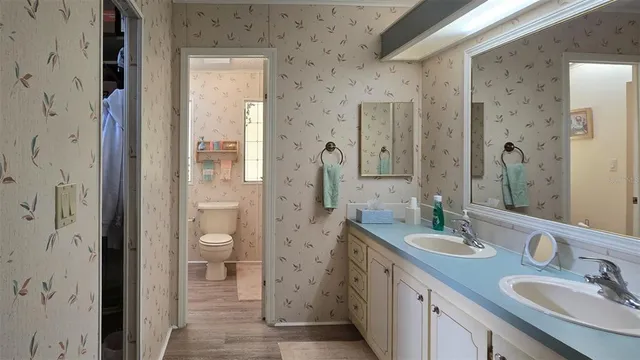 a bathroom with a granite countertop sink mirror and a shower