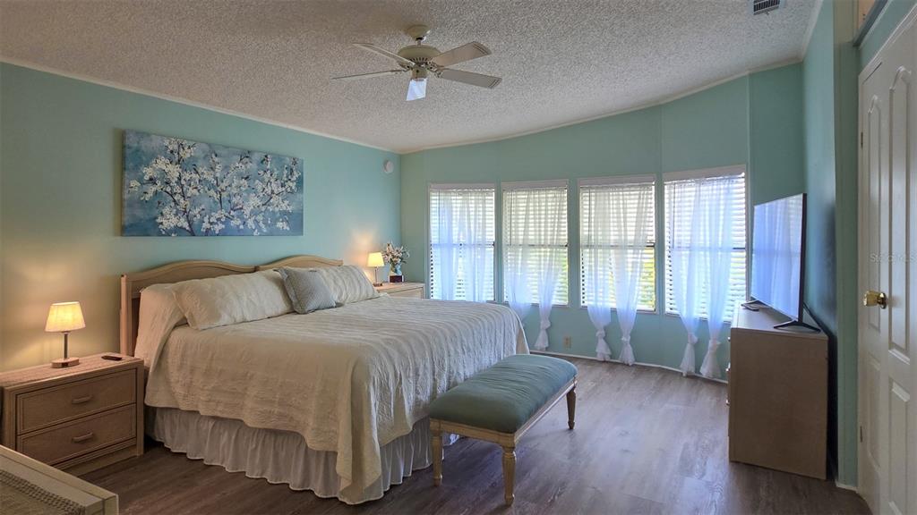 927 Yew Street Sebastian, FL 32976 - Photo 25 of 49 a spacious bedroom with a bed and a large window