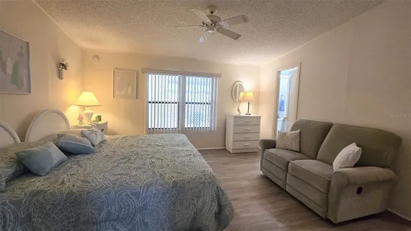 a bedroom with a bed couch and window