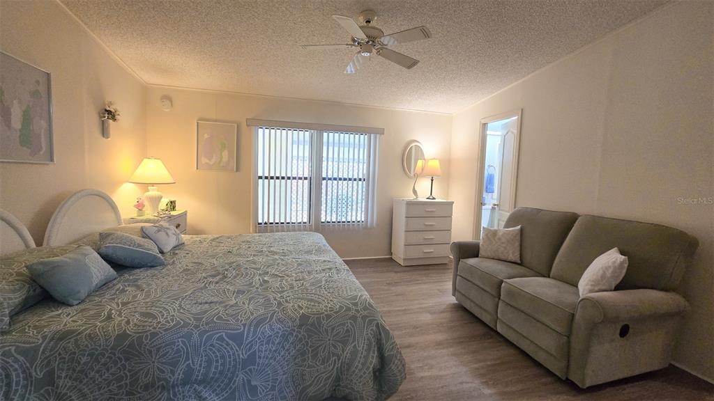 927 Yew Street Sebastian, FL 32976 - Photo 27 of 49 a bedroom with a bed couch and window