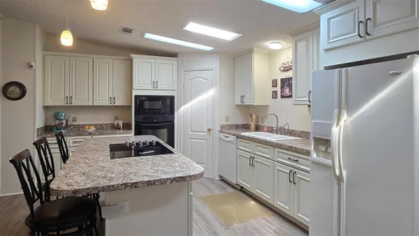 a kitchen with a stove a sink and a refrigerator