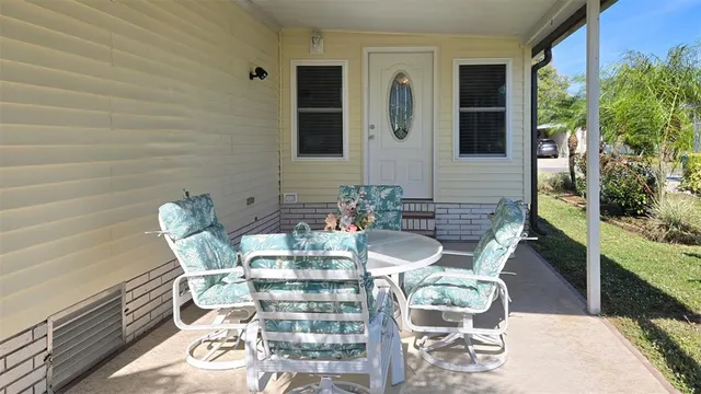 a view of a patio with table and chairs and potted plants