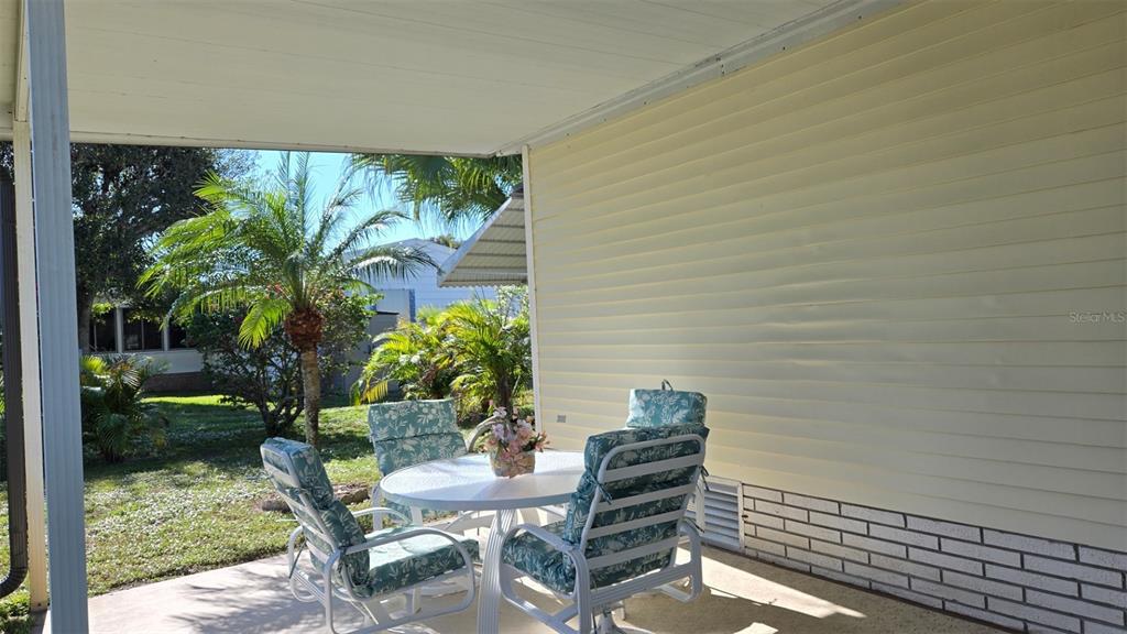 927 Yew Street Sebastian, FL 32976 - Photo 43 of 49 a view of a balcony with chairs and a potted plant